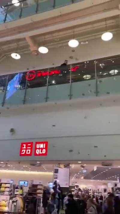 Russian man throwing money in a shopping mall because the ruble is effectively worthless