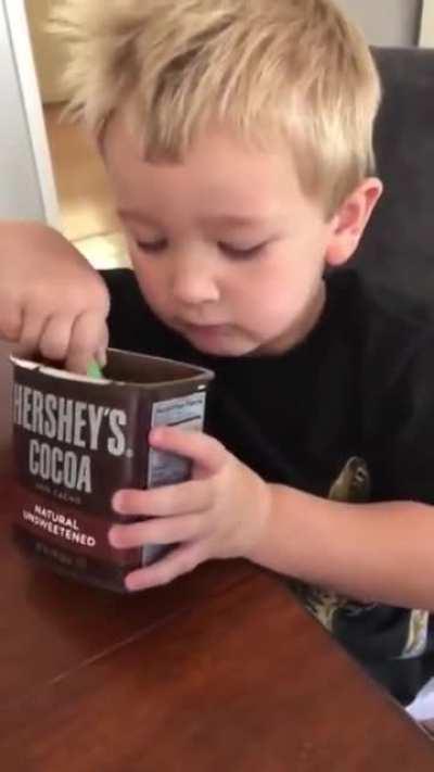Kid tries unsweetened cocoa powder