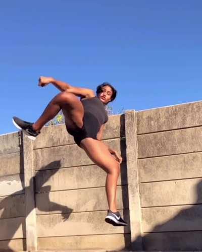 Kickboxing practitioner Alex Jay trying out a new kick. She knows that her form isn't there yet