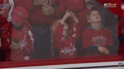 Hockey player try to give a puck to a young girl