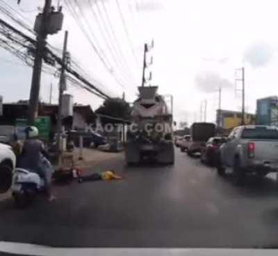 Biker Falls under truck