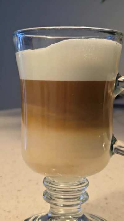 A little dance of milk and coffee in a fresh cappuccino.