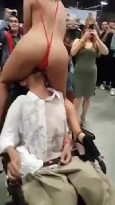 Adriana Chechik giving a disabled fan a taste