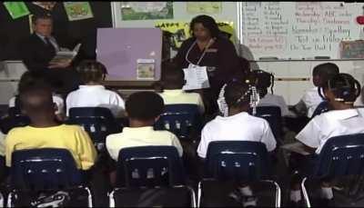 George W Bush being informed about the 9/11 attacks