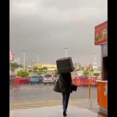 Plastic box to keep her hair from getting wet in the rain.
