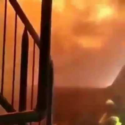 These Fire Fighters using a protective fire nozzle that makes a water type shield.