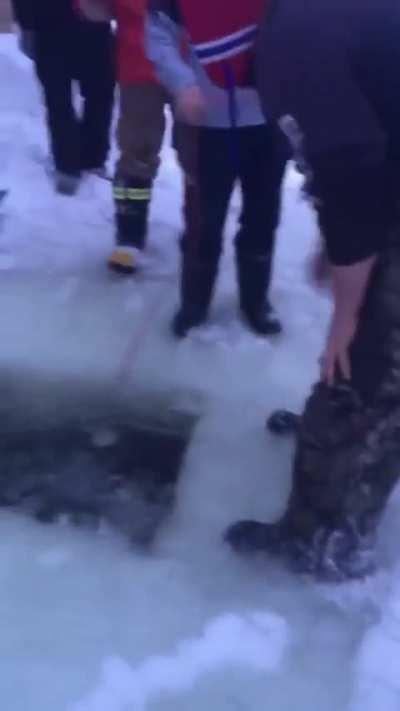 Dude loses his phone in a frozen lake so his friends help him retrieve it