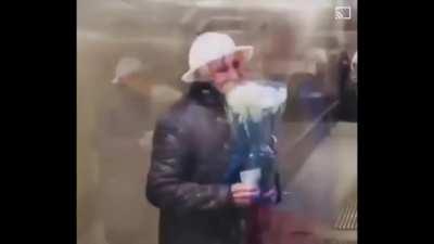 Boy buys a rose for an old woman