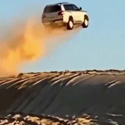 car flies over in the desert