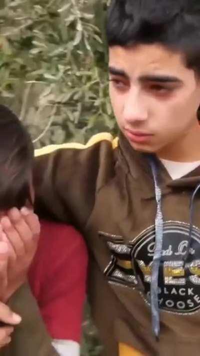 Women trying to stop the demolition of their home as armed soldiers try to enforce it