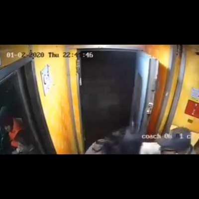 standing near a door on a moving train at night