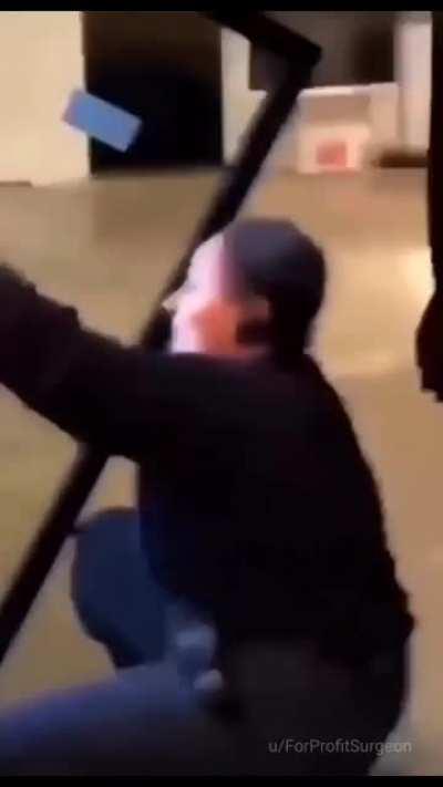 woman pulls fridge onto herself