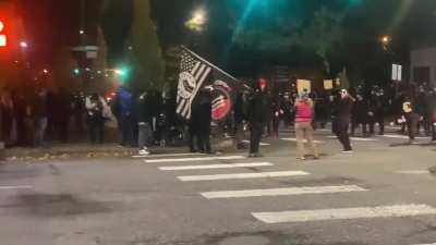 BLM-antifa shut down the road in Vancouver, Wash. A person wearing a clown mask waves an antifa flag (11/1/2020)