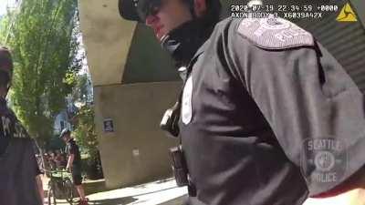 Man lures Seattle PD by blocking a camera with an umbrella, then rioters throw fireworks at them, some of which were covered in BBs