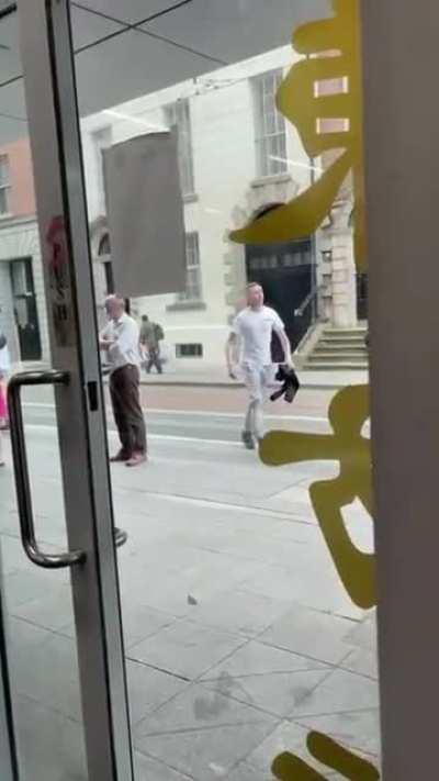 Young lad attempts to fight two older men.