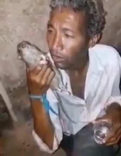 Random Brazilian man drunk and using a rat as a cellphone.