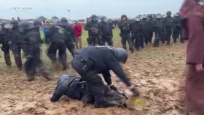 Mud wizard defeats a battalion of police, with mud