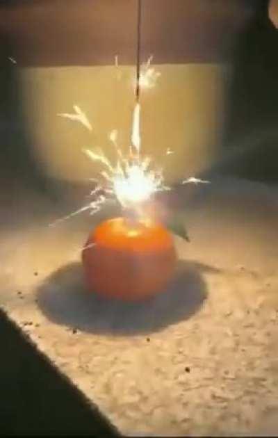 The remarkable effect of a sparkler burning inside a mandarin