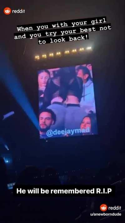 Woman twerks right behind couple at concert