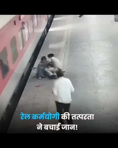 A police officer in India saving a woman from injury
