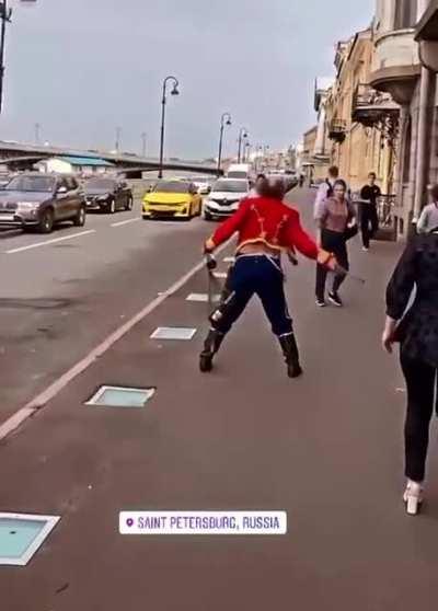 Drunk man in Imperial Russian uniform fights off invisible attackers with sword