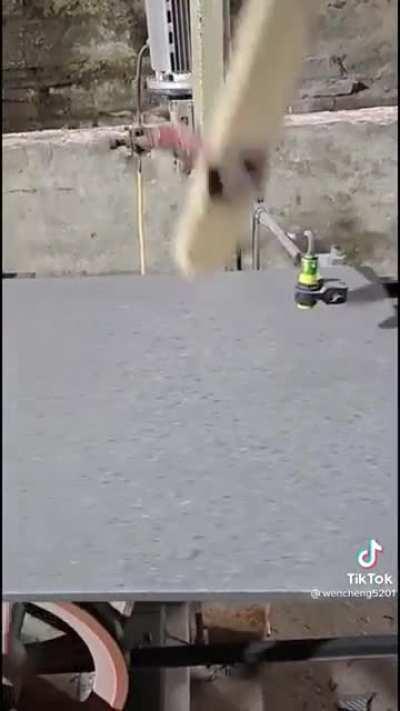 This robot hitting tiles with a plank of wood