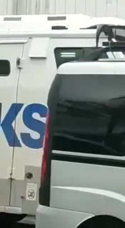 Armored truck guarded by a wooden slingshot and a caramelo dog