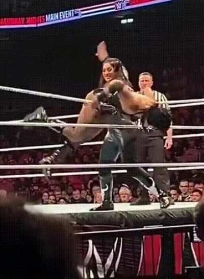 Raquel Rodriguez gives a spank to Rhea Ripley