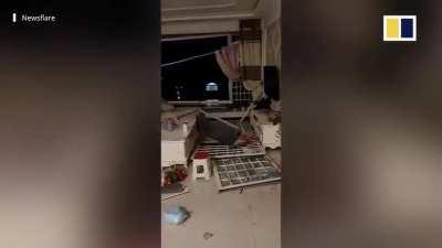 Strong winds batter China , ripping up roof