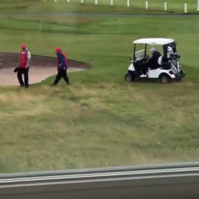 The President of the United States having his caddy kick his ball into a better lie.