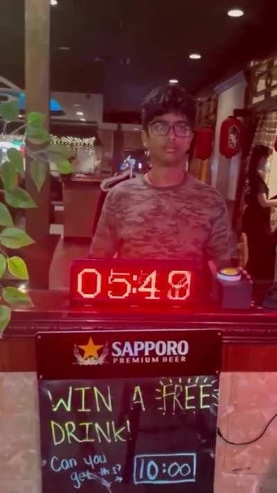guy wins a free beer by stopping the clock at exactly 10:00 seconds