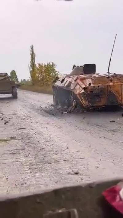 RU POV: Russian soldiers passing by five destroyed Ukrainian BTR-70s and one BTR-80 in the Kherson direction.
