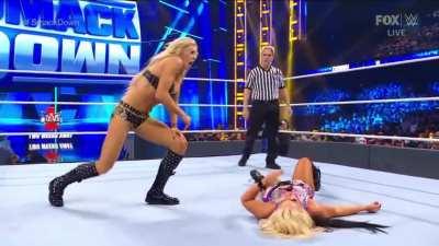 Charlotte walking over Toni Storm.