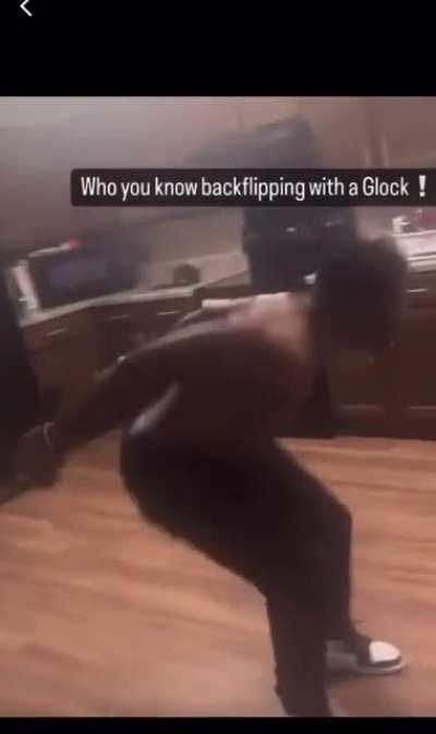 Idiot does backflip with guns. To his credit, he was practicing good trigger discipline