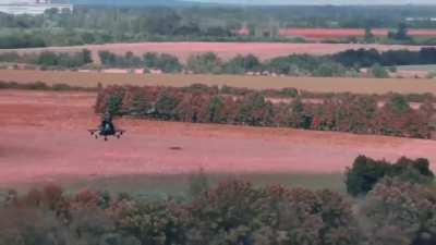 Ua pov A drone watches Ukrainian helicopters flying low and clearing treelines