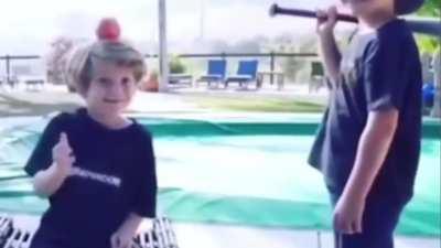 Kid with a bat and another with an apple. Wonder how this is going to end