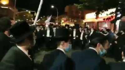 Orthodox Jews can't observe in the synagogues in New York so they've taken to the streets, and they've got Trump flags!