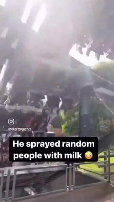 guy sprays random people with milk