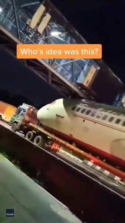 Driving under a low bridge while transporting an airplane... executed perfectly.