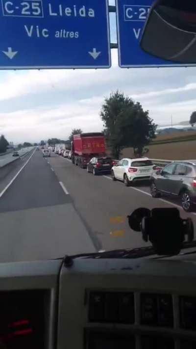 A bunch of idiots thought that the hard shoulder was the exit lane and started piling up behind a truck... who's telling them?