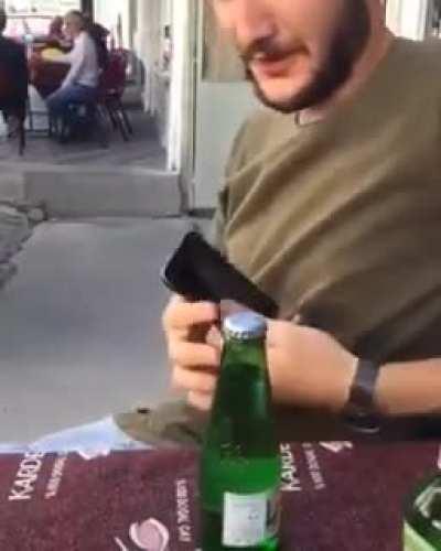 Attempting to open a bottle with a phone