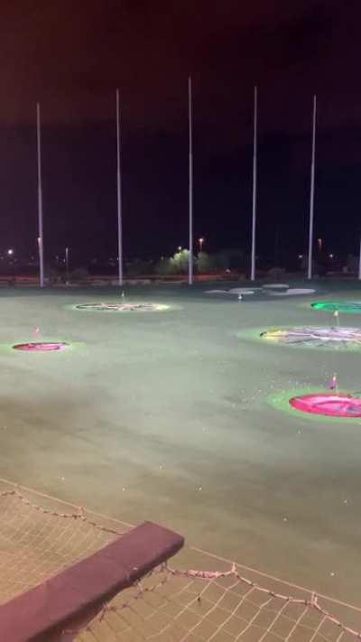 Guy runs out on field at topgolf while people are still hitting golf balls