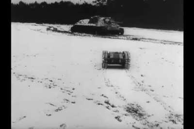 An obligingly stationary SU-85 SPG blown up by a Goliath demolition vehicle