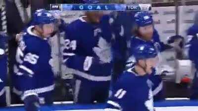 Hyman celebrates after his goal with Wayne Simmonds on the bench