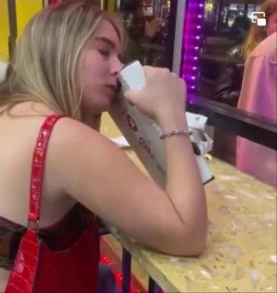Woman calmly eats a pizza box