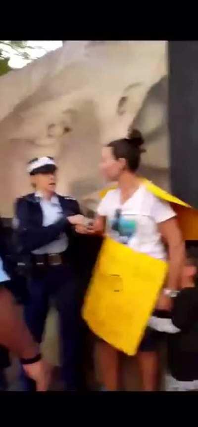 New South Wales police drag off a young mother in front of her screaming son for using her democratic right to protest, watch the smirking scumbag taunt the person filming too.