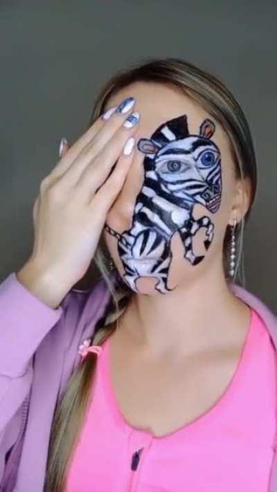 Woman paints a zebra on her face and makes it twerk