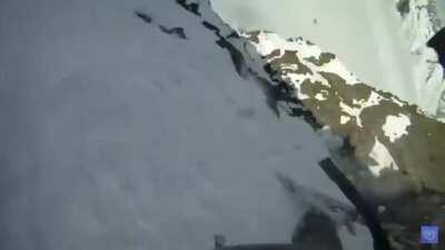 Putting skis on on the edge of a cliff