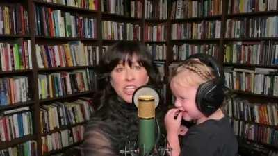 Alanis Morissette trying to perform on the Tonight Show, but her daughter keeps interrupting her.