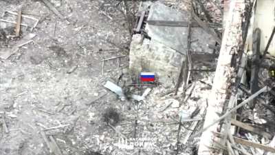 Russian soldier was trying to clear the ruins when he was killed through a wall by small arms fire.